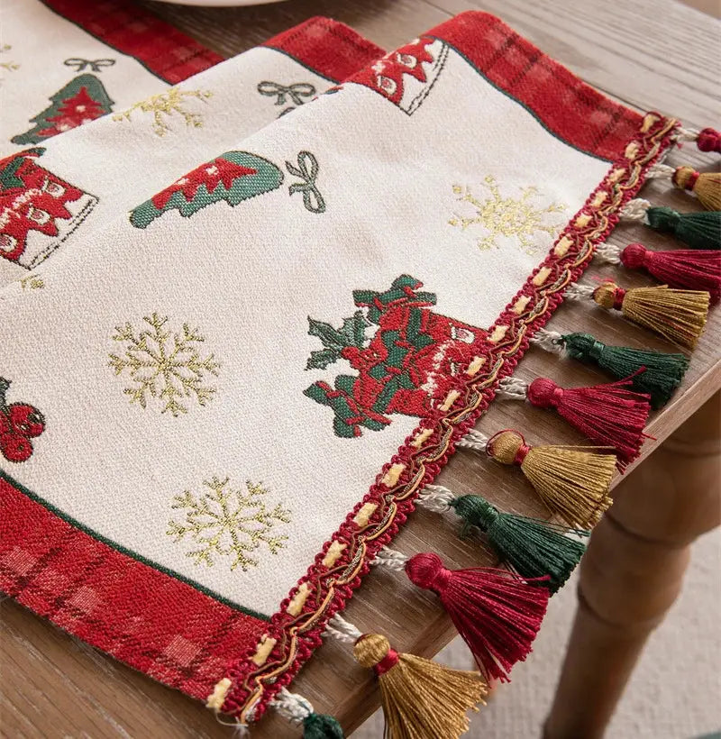 DecorBites™ christmas table runner with embroidered tassel features red and green holiday motifs and gold snowflakes for dining room decor