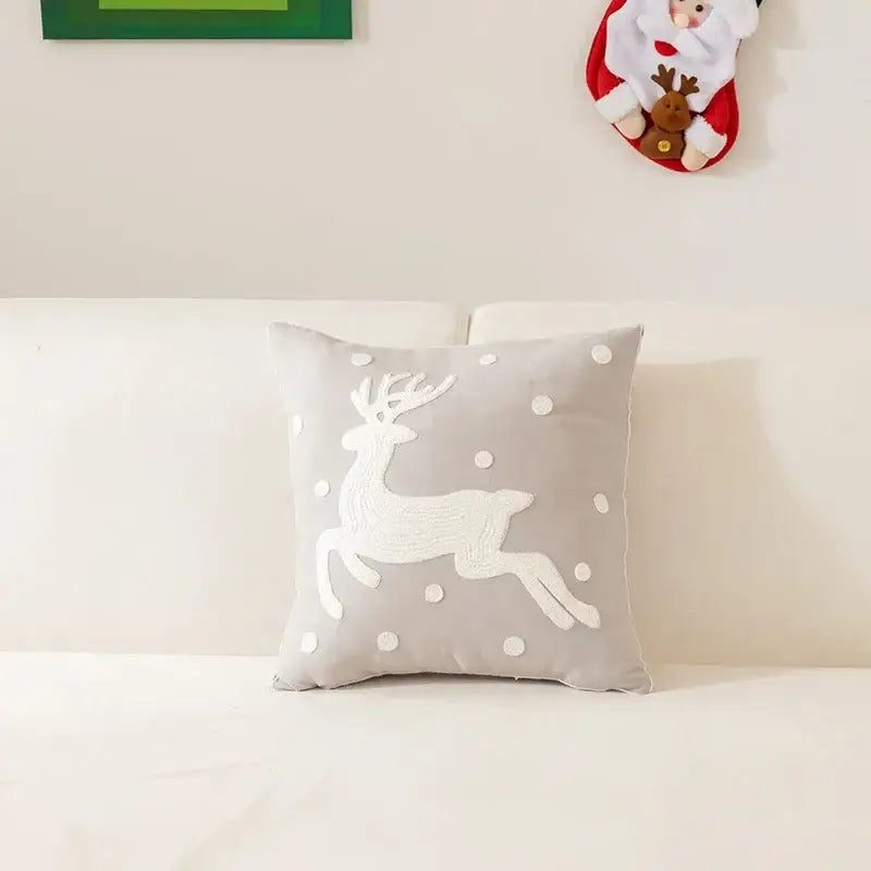 Gray pillow cover with white embroidered reindeer and pom-pom snowflakes from decorbites christmas cartoon letter collection