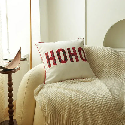 White cushion pillow cover with red ho ho lettering in plaid pattern and red stitched border decorbites christmas cartoon