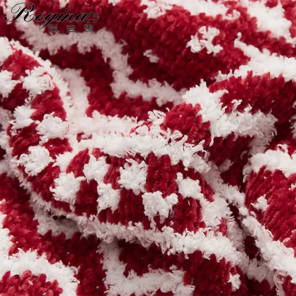 Red and white striped plush fabric of decorbites christmas chunky knit blanket with fluffy textured microfiber tufted design