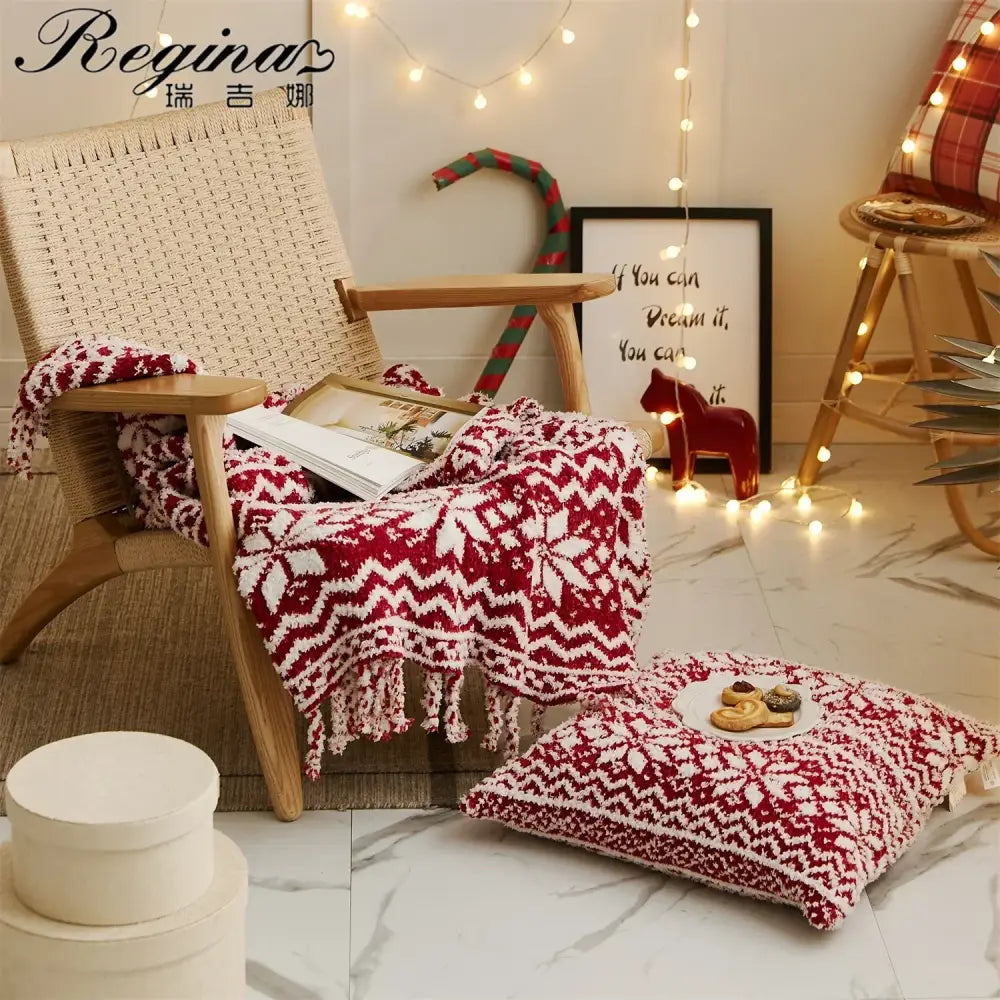 Decorbites christmas chunky knit blanket in red and white microfiber with festive snowflake pattern draped on woven chair