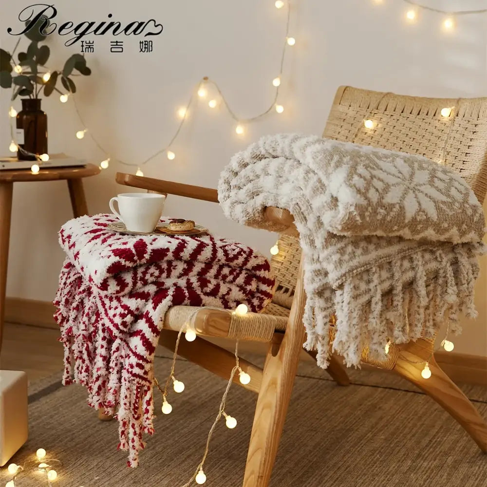A decorbites christmas chunky knit blanket in red and white microfiber with snowflake pattern draped over wooden chair