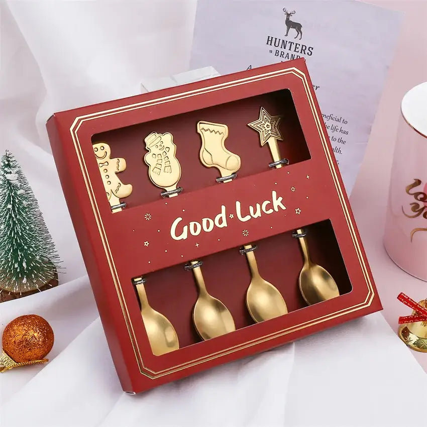 Gold-colored stainless steel christmas coffee spoons set in a red gift box with good luck print by decorbites