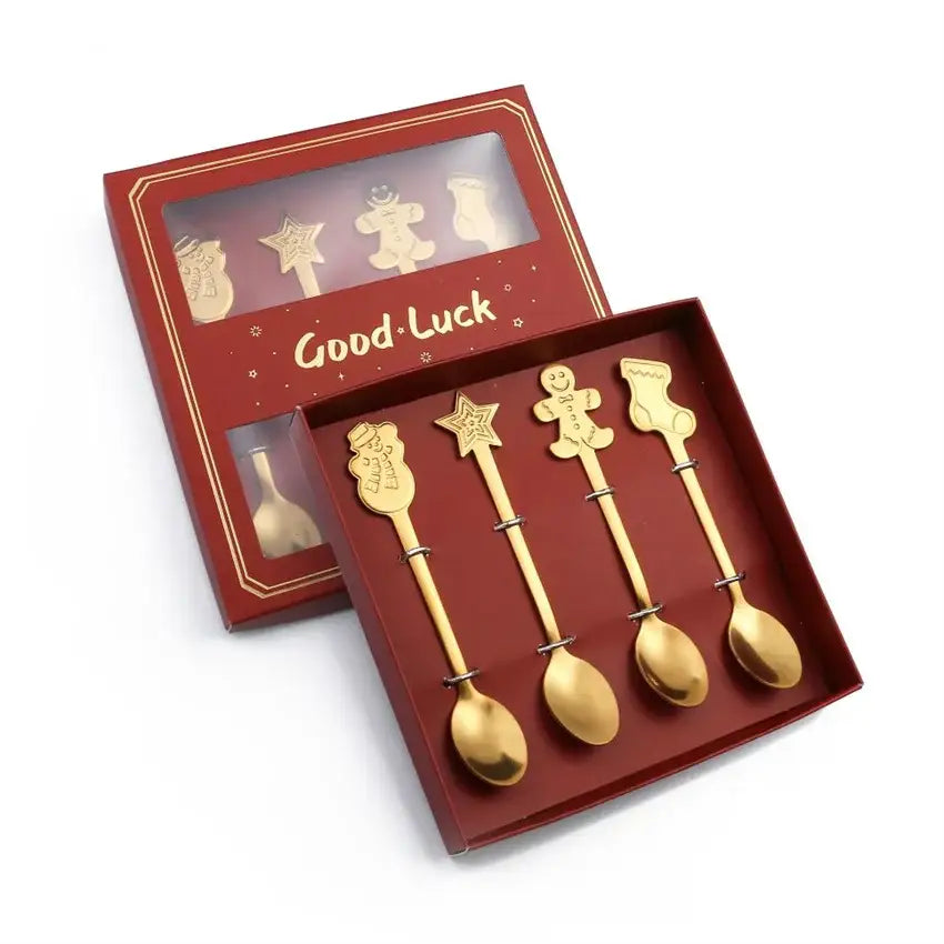 Set of four gold-colored stainless steel christmas coffee spoons with stocking star gingerbread man and snowman designs