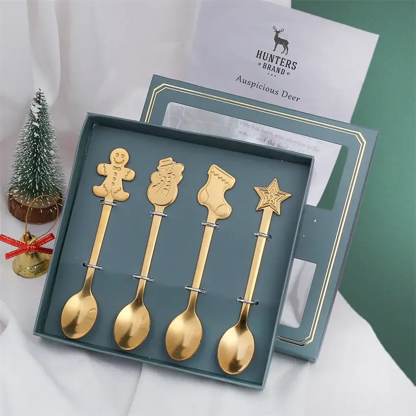 Set of four gold-colored stainless steel christmas coffee spoons with festive gingerbread, snowman, stocking, and star designs