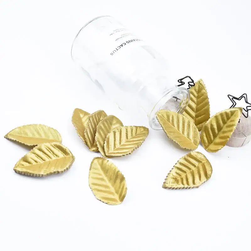 Golden leaf-shaped decorbites christmas crafts silk leaf with textured surface and serrated edges for decorative use