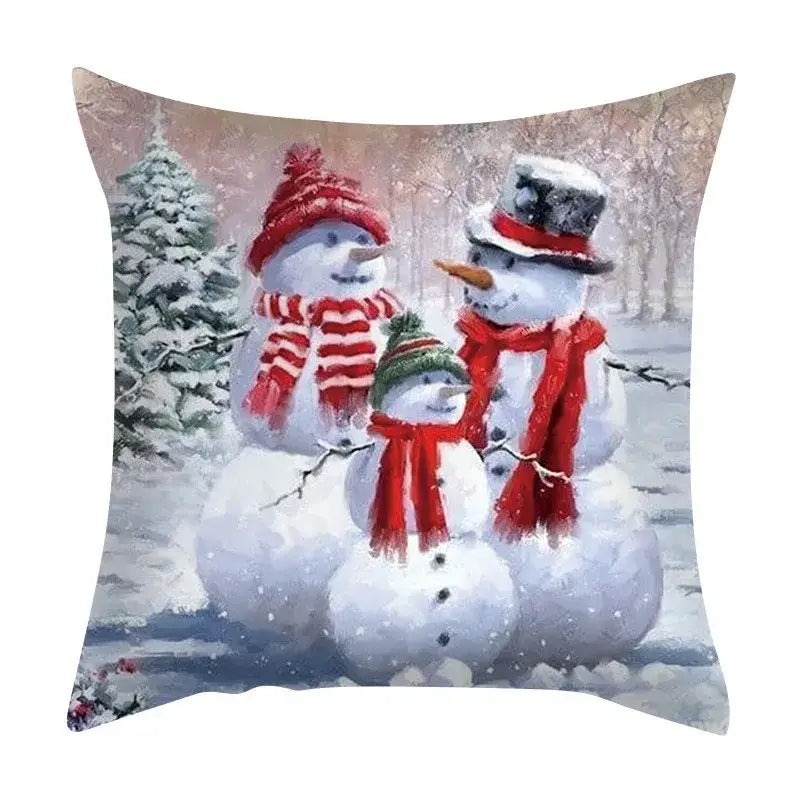 Square decorbites christmas cushion featuring a painted scene of three snowmen in a snowy forest for festive home decor