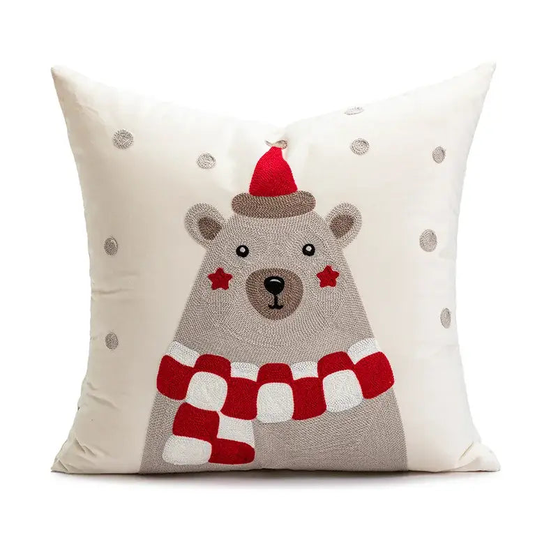 Cream-colored decorbites christmas day throw pillow with embroidered bear in santa hat and silver sequin snowflakes
