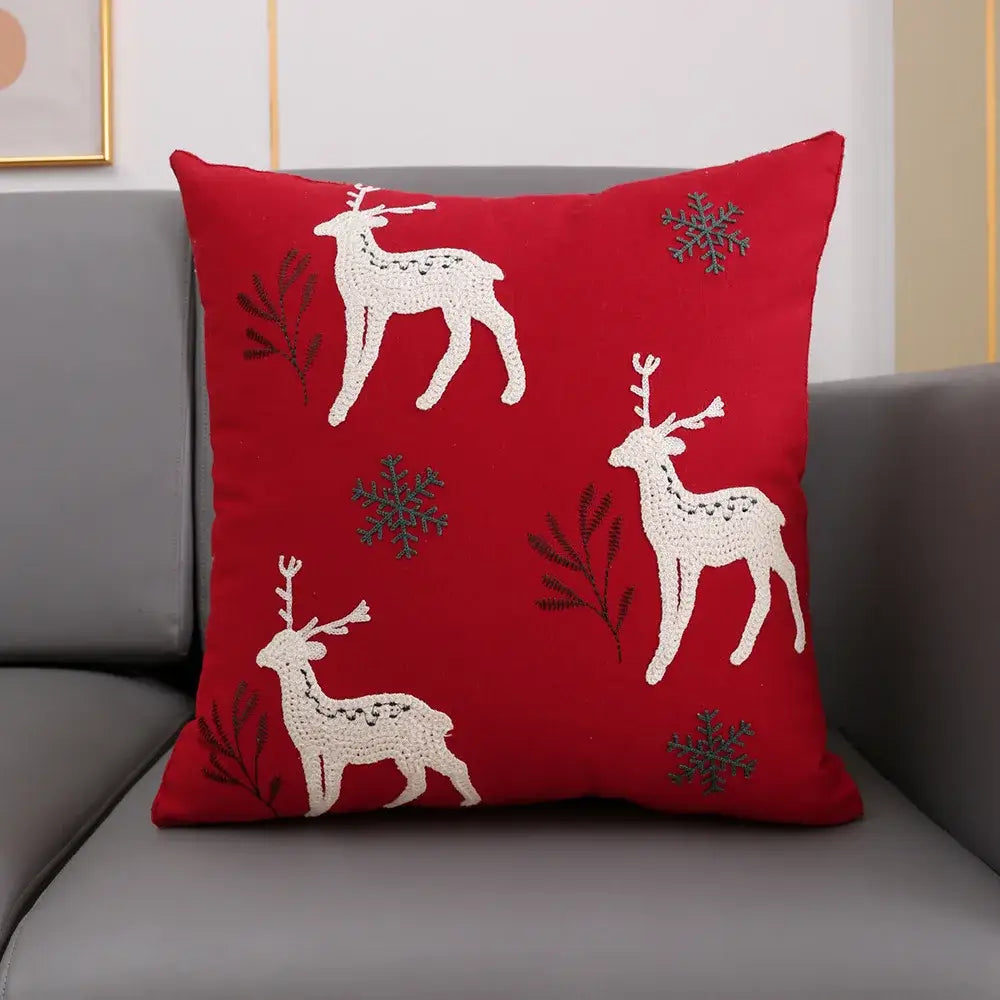 Red cushion cover with embroidered white reindeer and gray snowflakes from decorbites christmas décor collection
