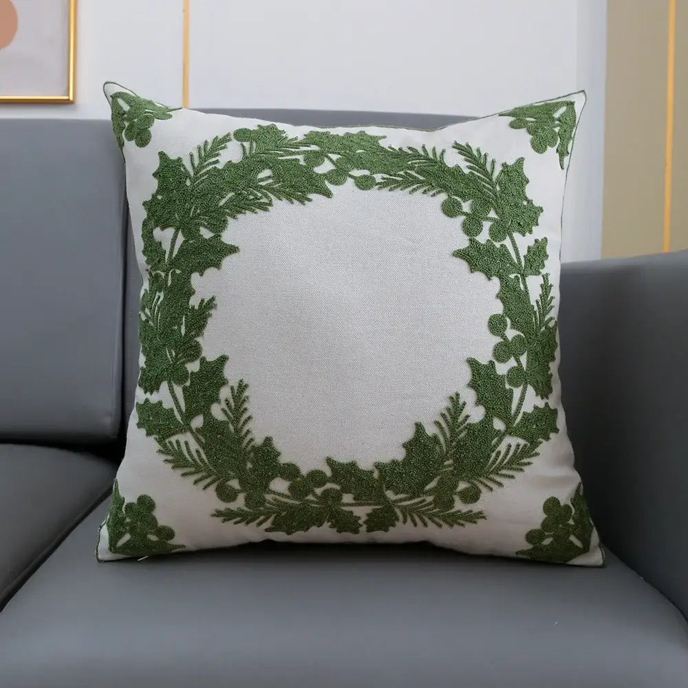 White cushion cover with embroidered green holly wreath from decorbites christmas décor collection 45x45cm