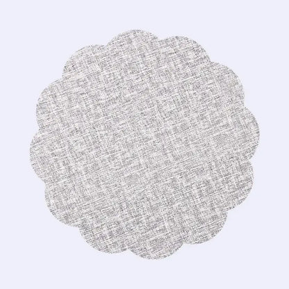 A circular scalloped-edged gray linen placemat with subtle woven texture in decorbites christmas decor placemat set