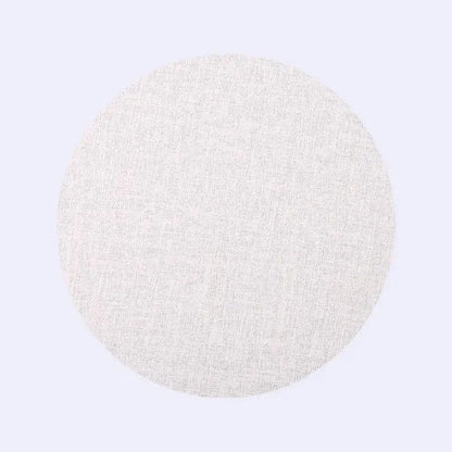 A circular off-white woven fabric disc in decorbites christmas decor placemat and coaster set for elegant dining