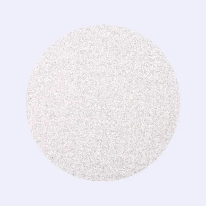 A circular off-white woven fabric disc in decorbites christmas decor placemat and coaster set for elegant dining