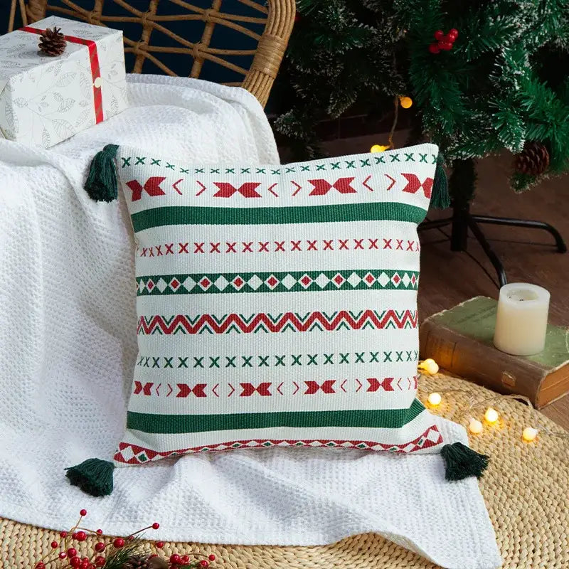 White throw pillow with red and green geometric patterns and handmade dark green tassels decorbites christmas decoration cushion cover
