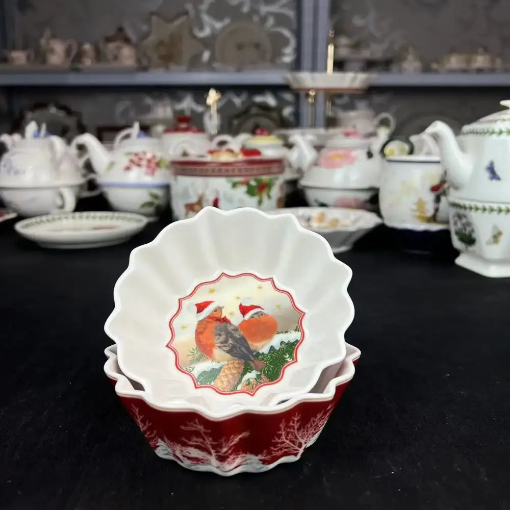 White ceramic bowl with scalloped edges and red gold bird illustration from decorbites christmas dinnerware set