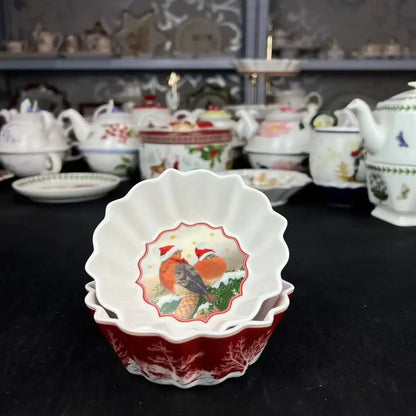 White ceramic bowl with scalloped edges and red gold bird illustration from decorbites christmas dinnerware set