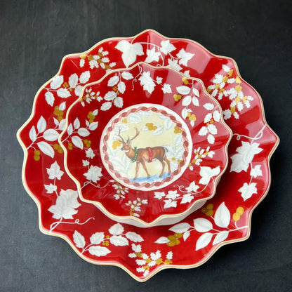 Red ceramic serving bowl with scalloped edges and deer winter design from decorbites christmas dinnerware set