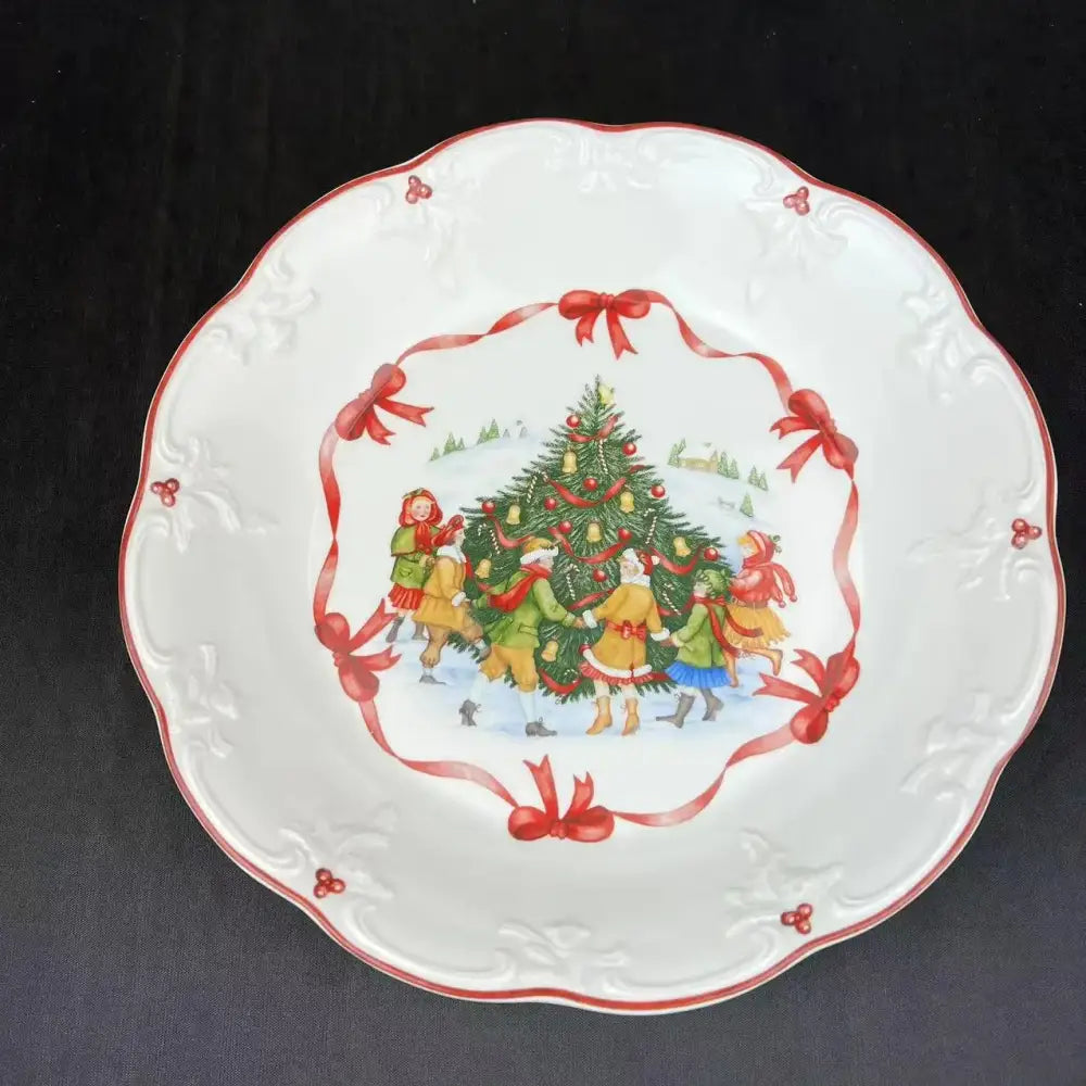 White ceramic bowl with scalloped edges red trim and festive children decorating tree design from decorbites christmas dinnerware set
