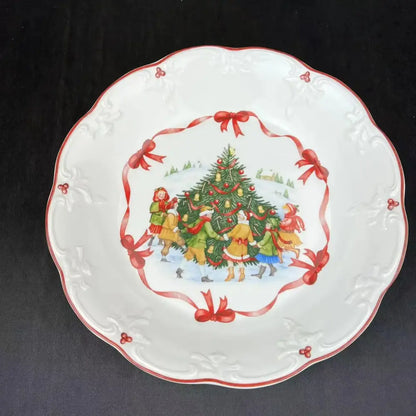 White ceramic bowl with scalloped edges red trim and festive children decorating tree design from decorbites christmas dinnerware set