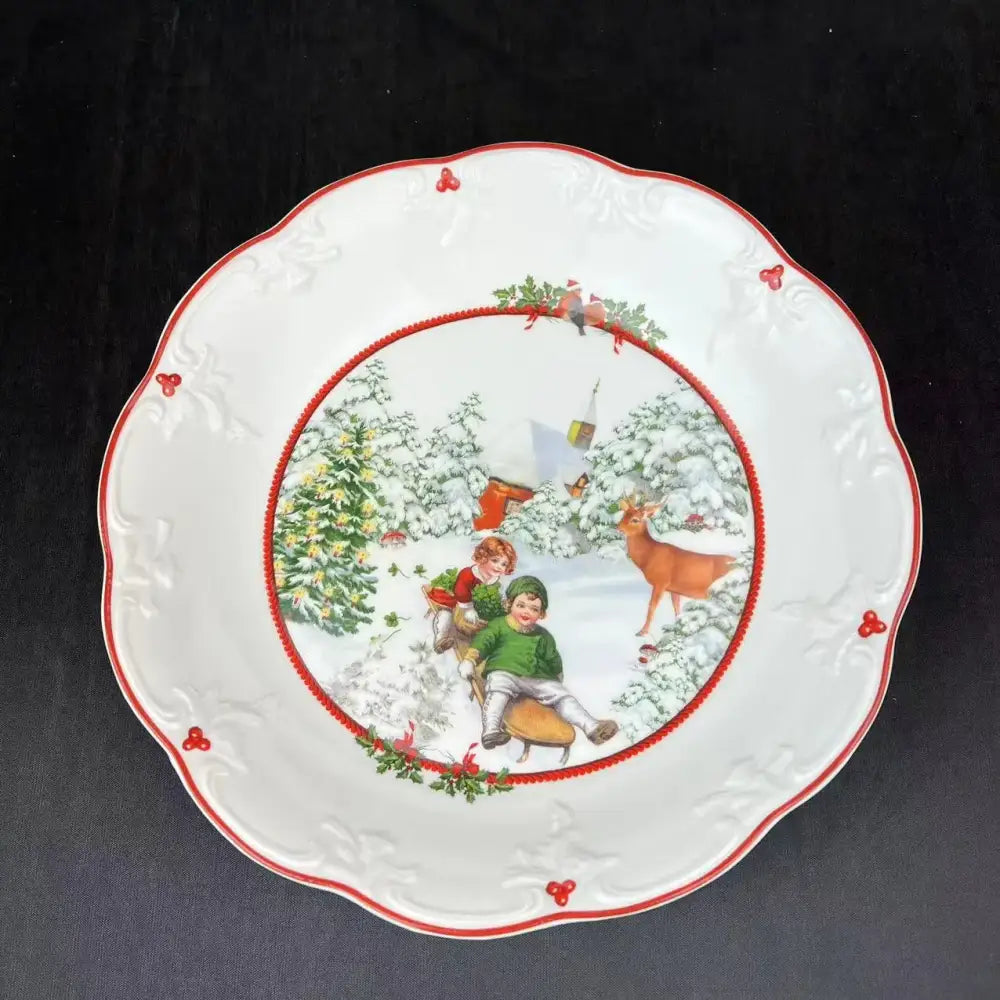 White ceramic christmas plate with red scalloped edge and sledding children scene for decorbites christmas dinnerware set
