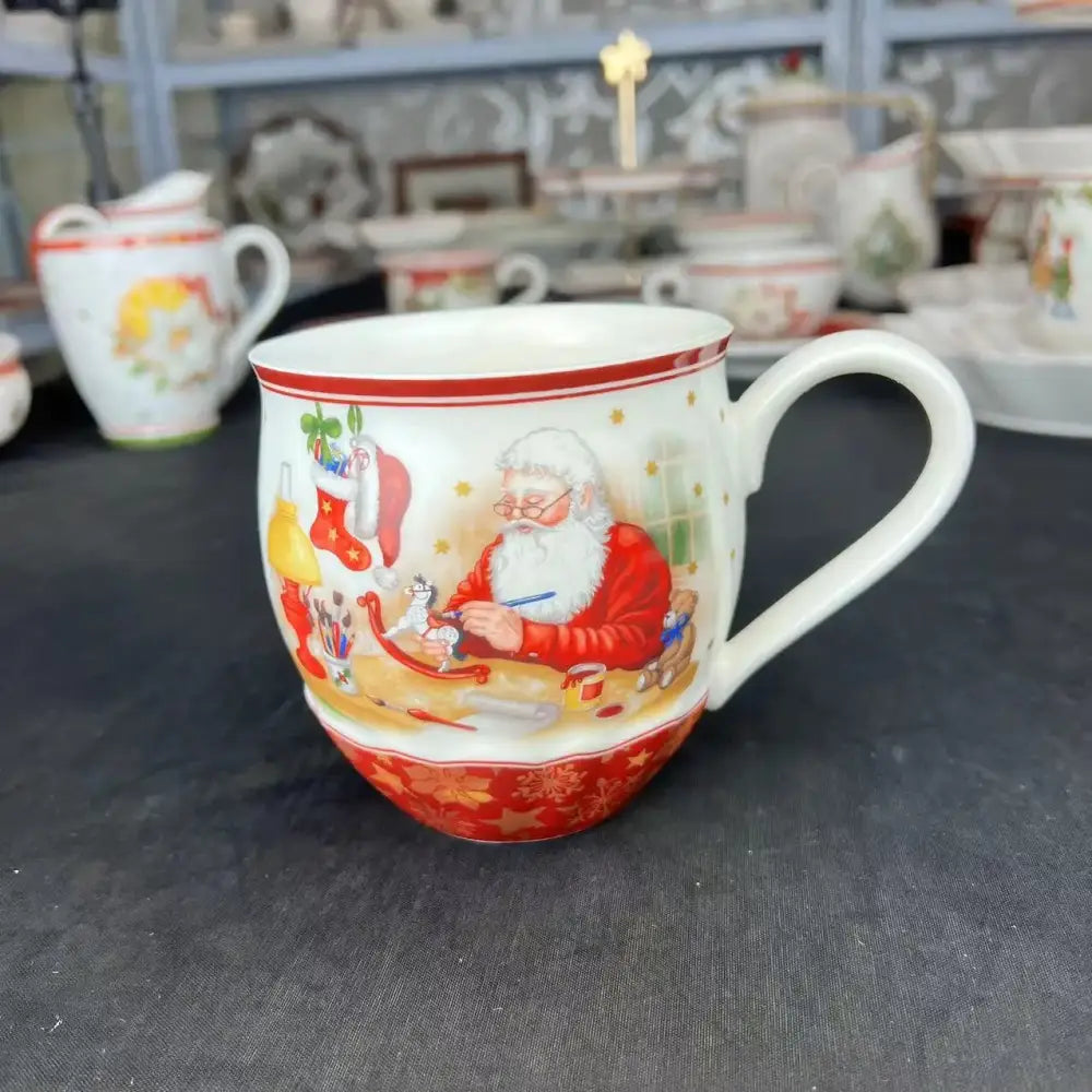 White ceramic mug with red decorative bands and santa claus illustration from decorbites christmas dinnerware set