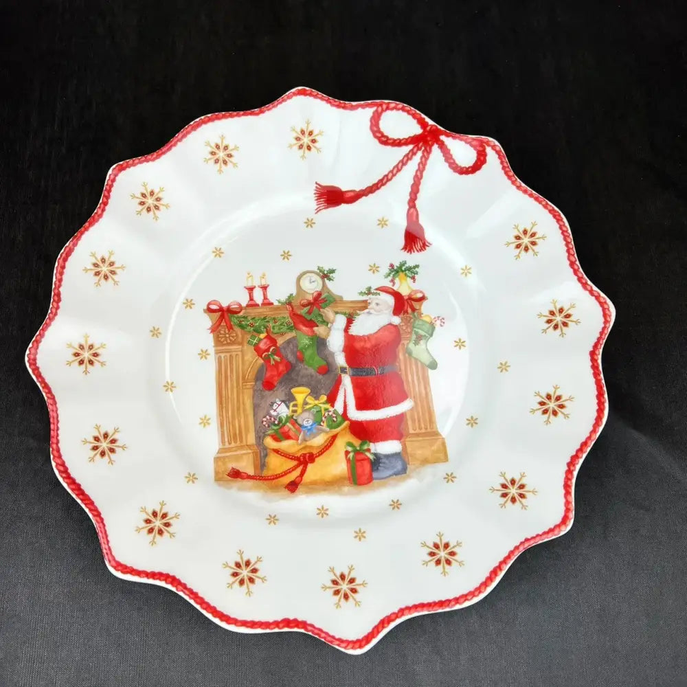 White ceramic plate with scalloped edge and santa claus design from decorbites christmas dinnerware set