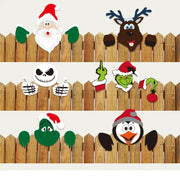 Wooden fence decorated with decorbites christmas door frame set featuring festive santa reindeer and cartoon character cutouts