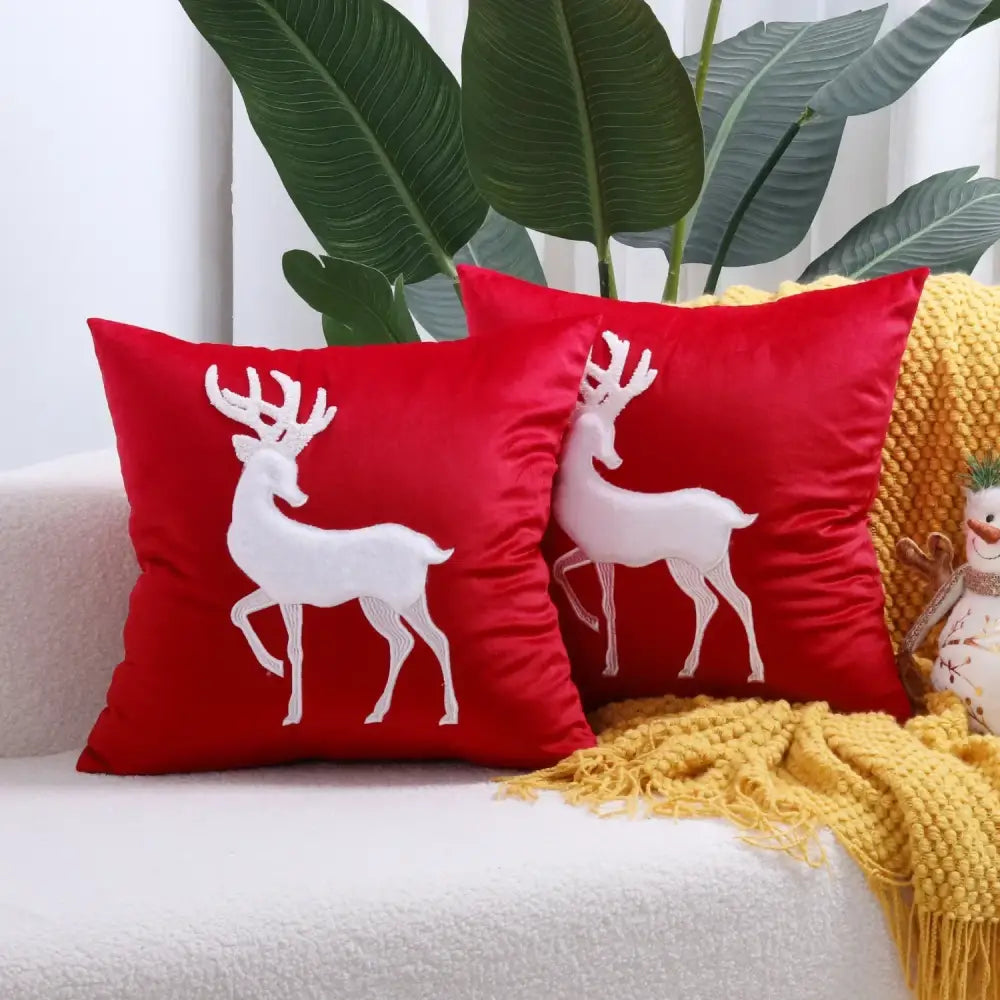 Red velvet pillow cover with white embroidered christmas elk design by DecorBites for festive decoration