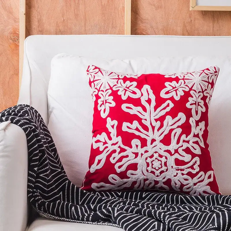 Vibrant red decorbites christmas embroidered cotton pillow covers with intricate white floral and snowflake patterns