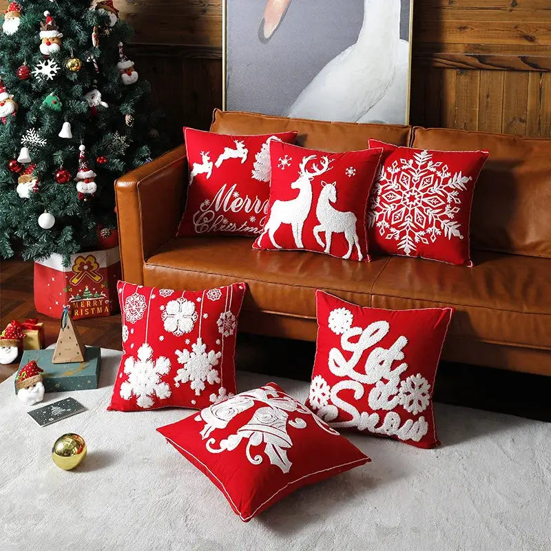 Red christmas embroidered cotton pillow covers by decorbites featuring reindeer snowflakes and holiday phrases