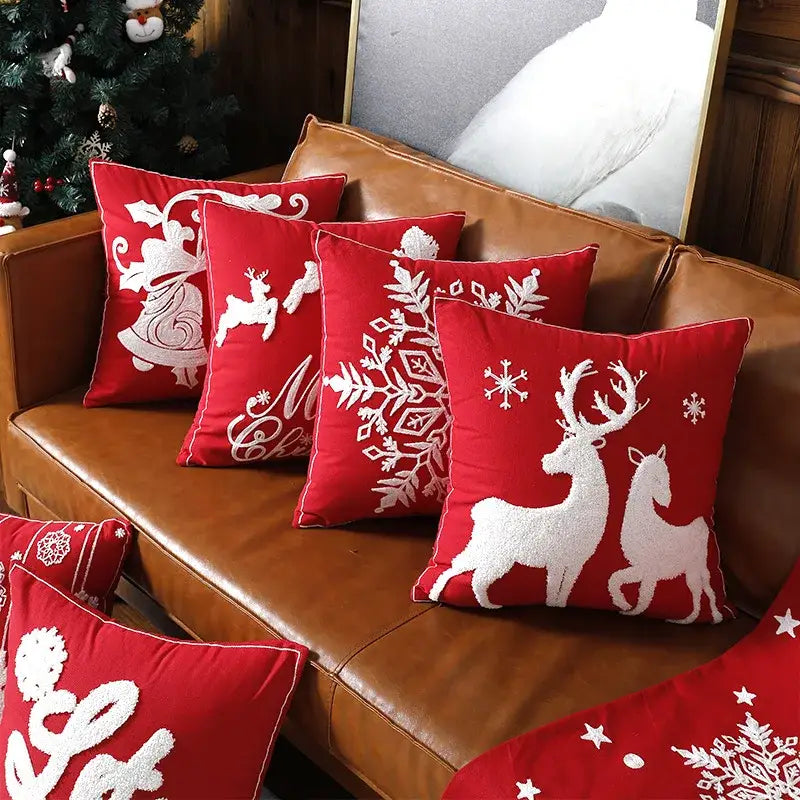 Red christmas embroidered cotton pillow covers by decorbites featuring white reindeer snowflakes and holiday motifs