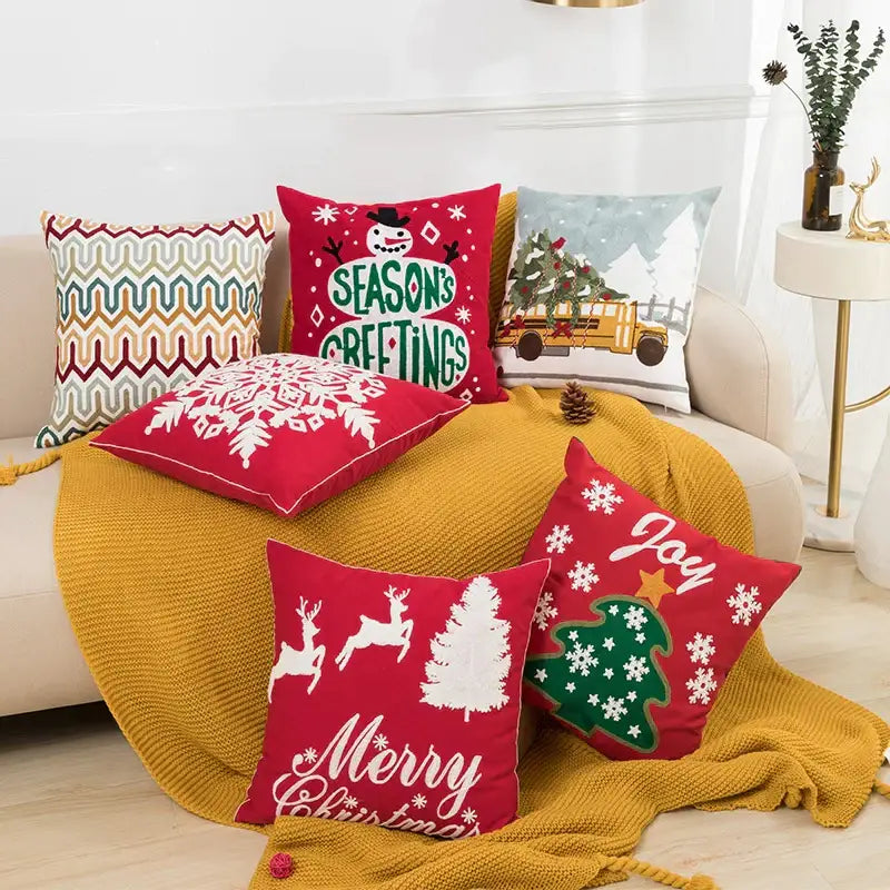 Red decorbites christmas embroidered cushion cover with snowflake and reindeer on mustard yellow knitted blanket