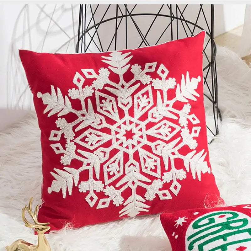 Red velvet cushion cover with intricate white embroidered snowflake design by decorbites christmas embroidered collection