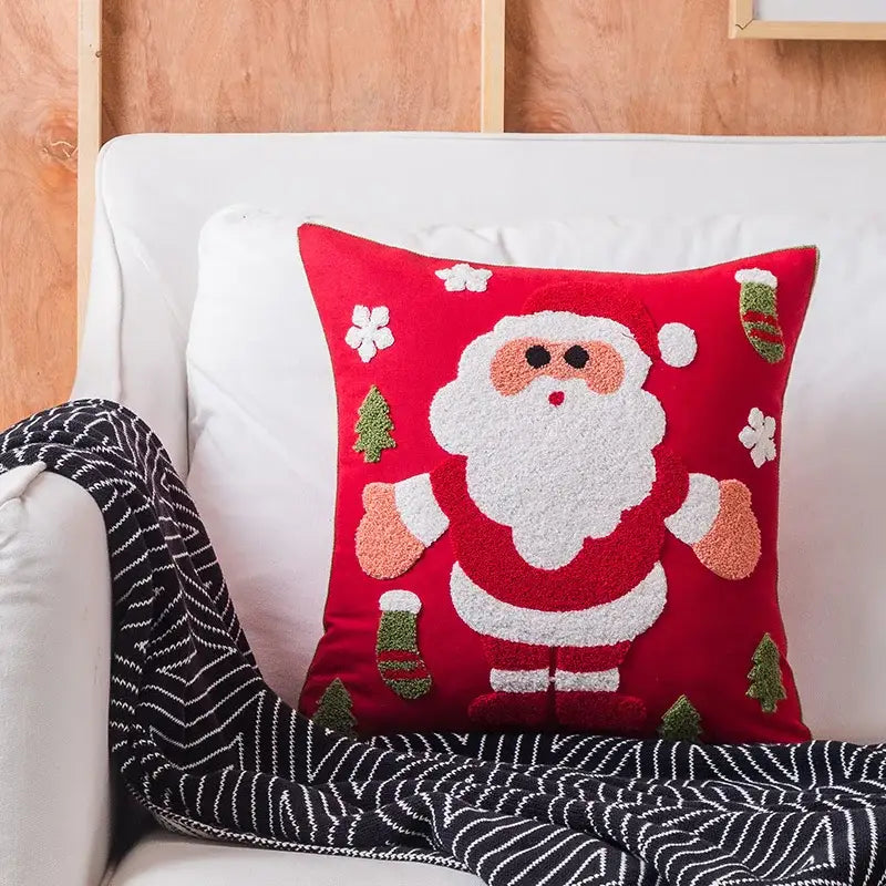 Red decorbites christmas embroidered cushion cover featuring santa claus with white beard surrounded by trees and snowflakes