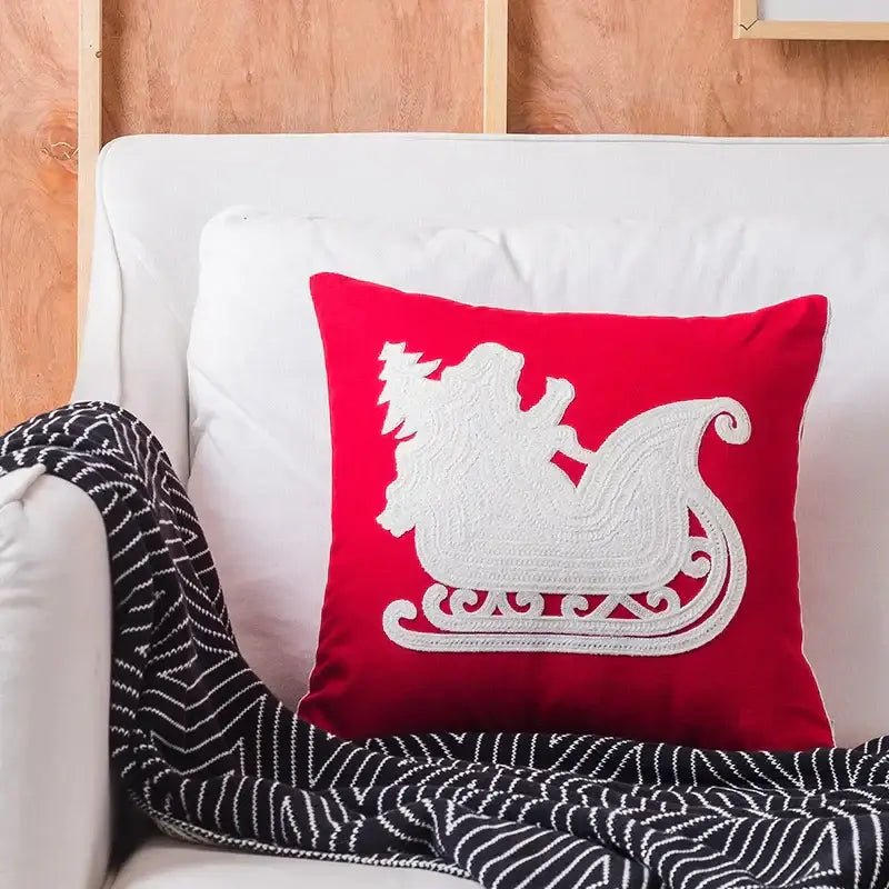 Red square cushion cover with white embroidered sleigh design from decorbites christmas embroidered collection