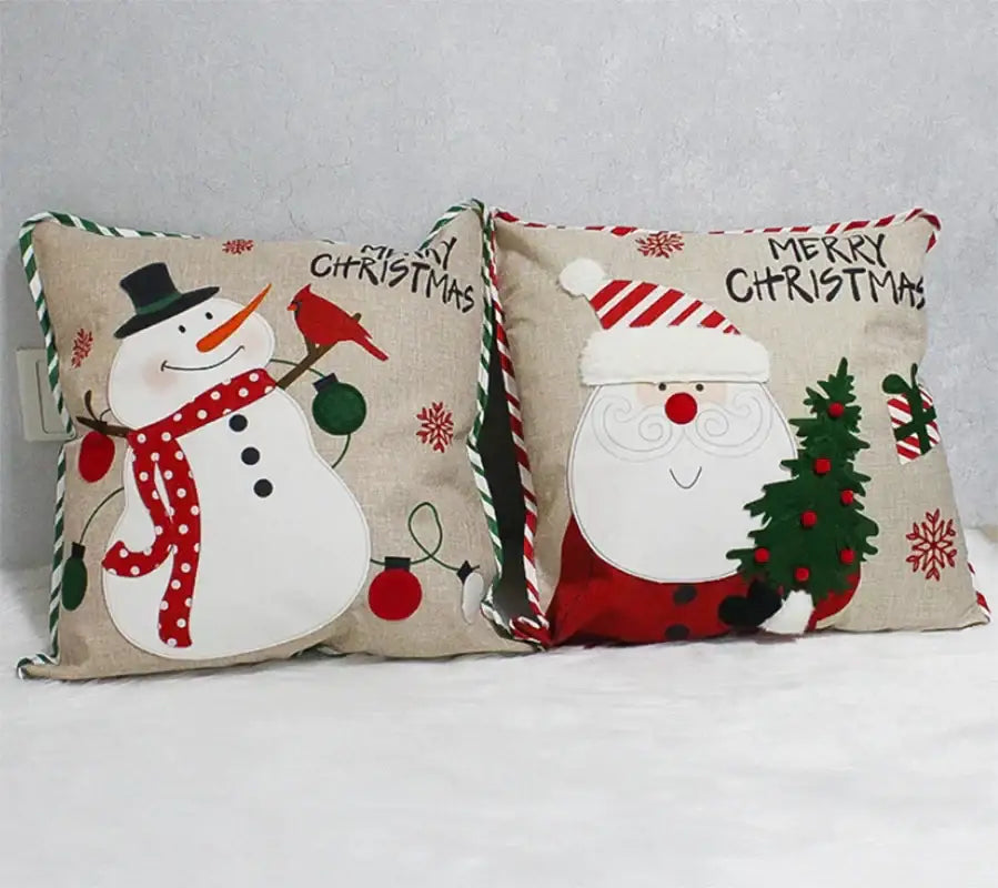 Two decorbites christmas embroidered pillowcases with snowman and santa designs on beige fabric with striped ties