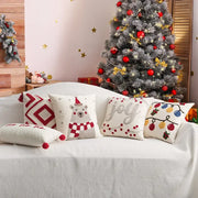 Set of cream cushion cover with decorbites christmas embroidered red festive designs featuring polar bear and ornaments