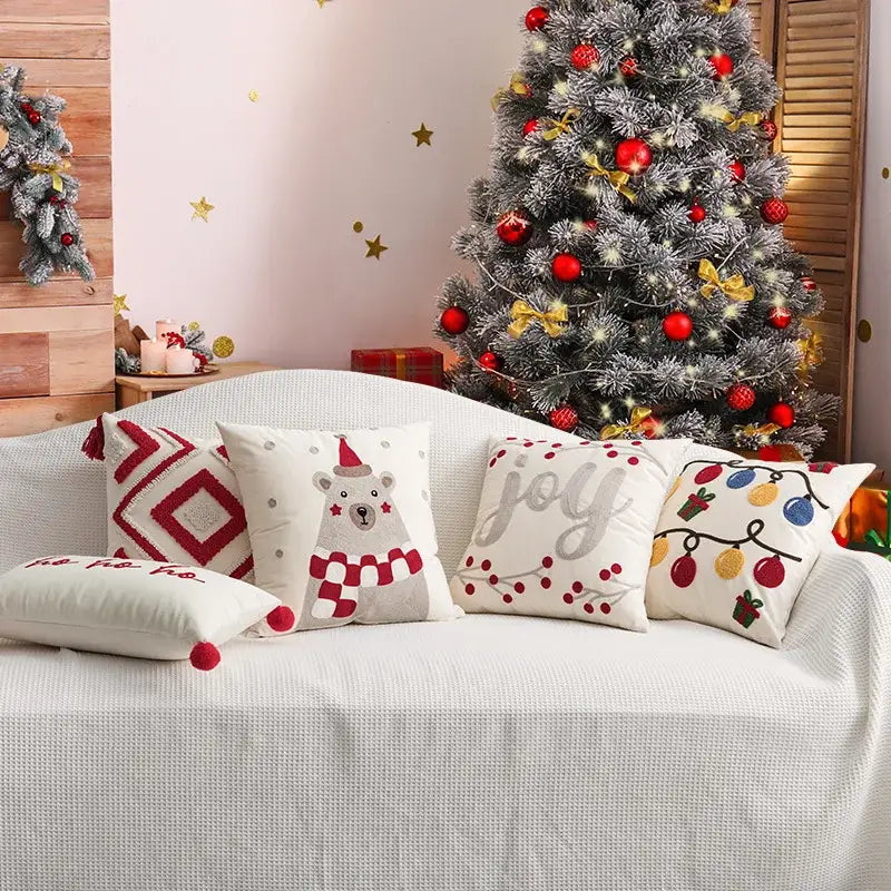 Set of cream cushion cover with decorbites christmas embroidered red festive designs featuring polar bear and ornaments