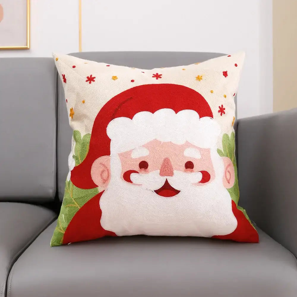 Cream-colored cotton decorbites christmas embroidery cushion cover featuring santa claus and festive foliage patterns