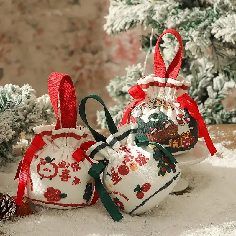 White fabric decorbites christmas eve apple bags with festive prints and red or green ribbons for santa candy gifts