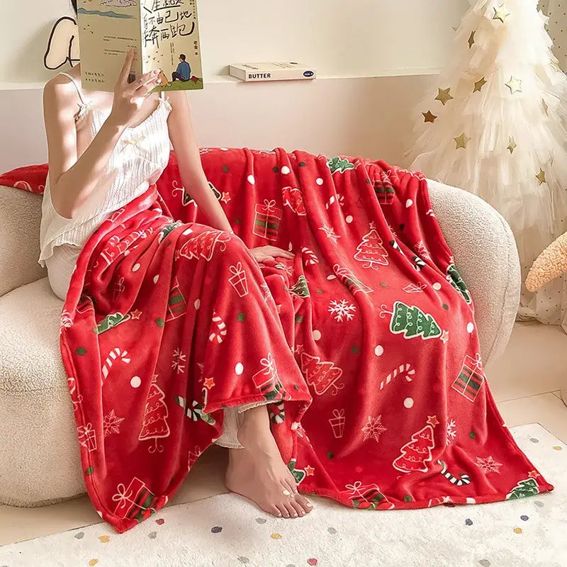 Red plush decorbites christmas flannel blanket with green trees candy canes and gift boxes printed in white