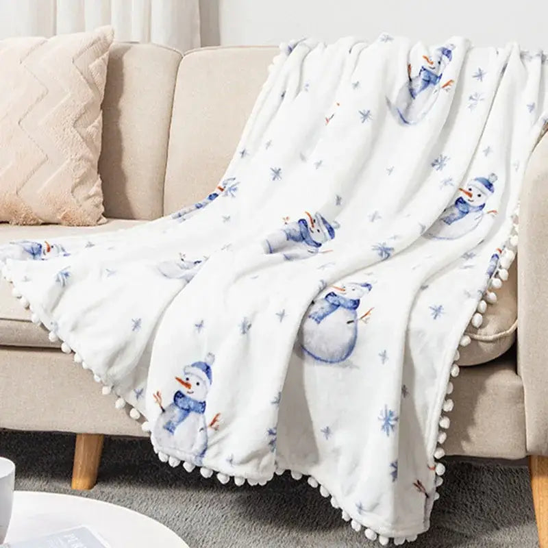 White plush decorbites christmas flannel blanket with blue snowman star patterns and white pom-pom trim for winter use