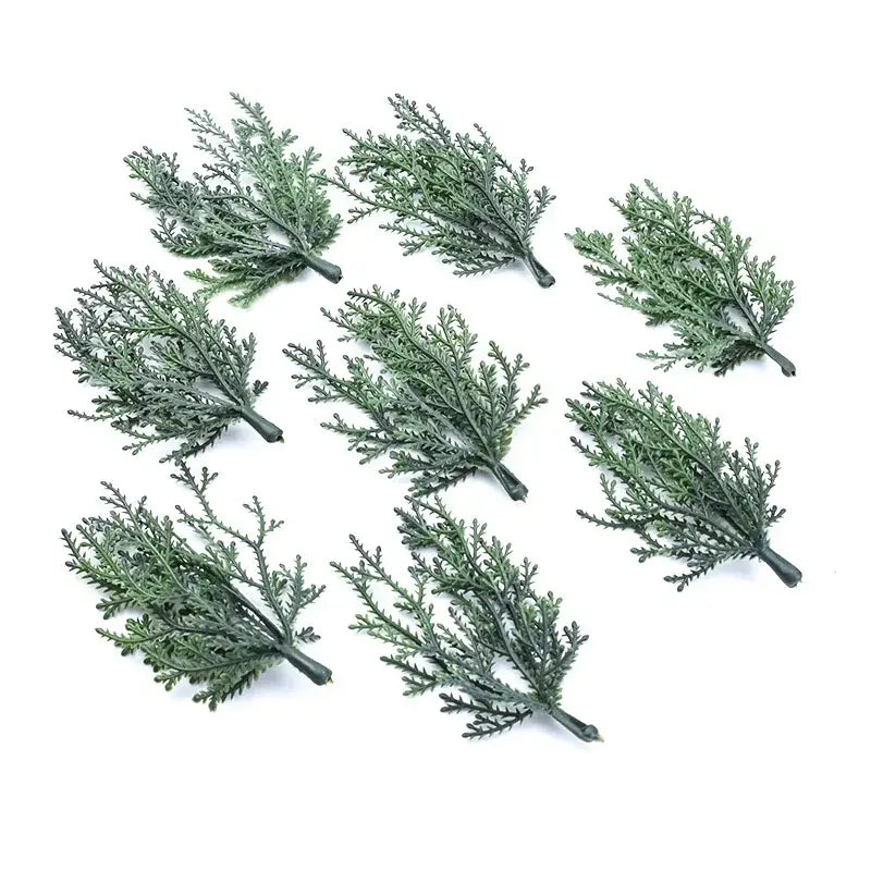 Green artificial foliage sprigs made of plastic with realistic texture and layered leaves for DecorBites christmas garland home decor