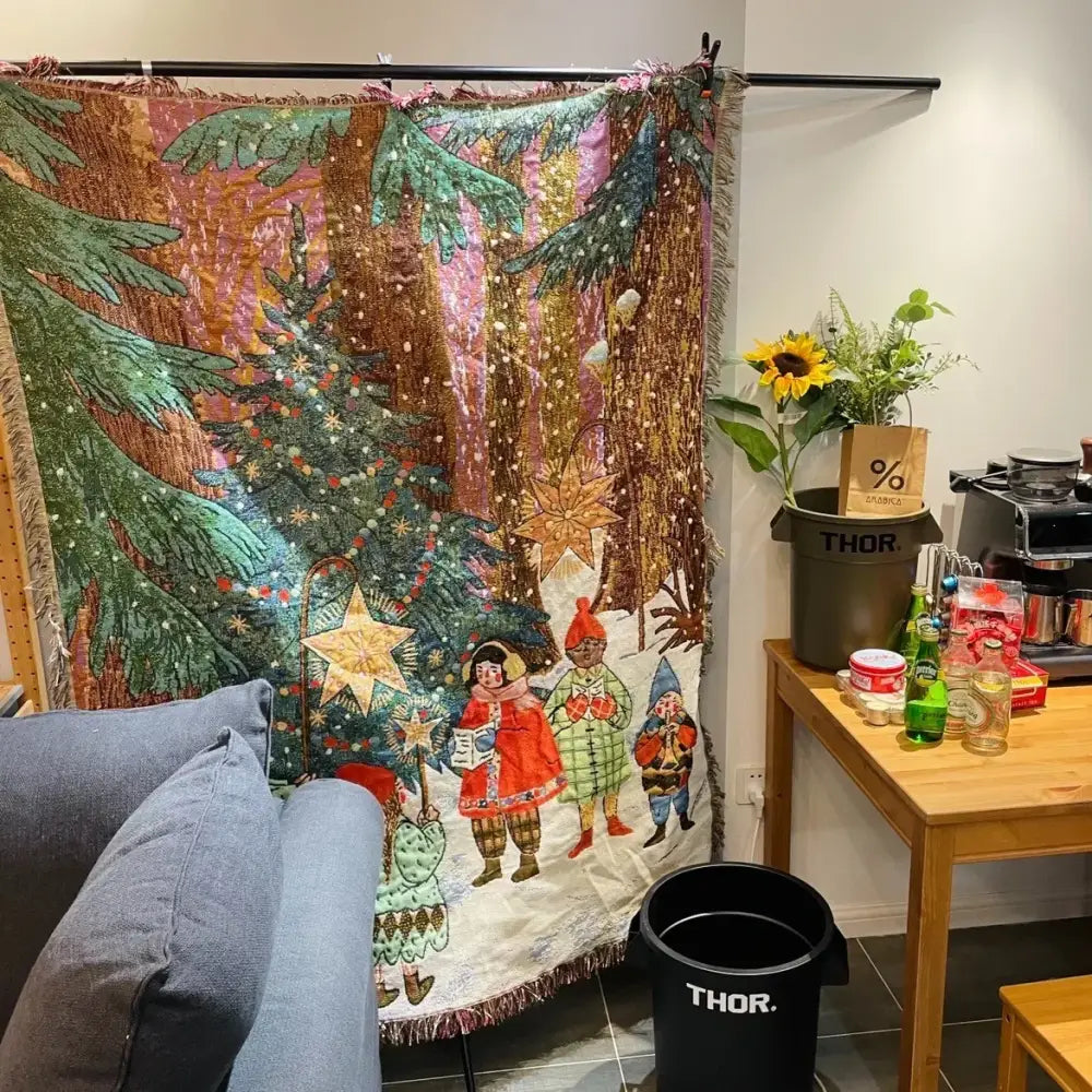 A decorbites christmas holiday sofa blanket with a festive tapestry of snow trees ornaments and cheerful figures in winter attire