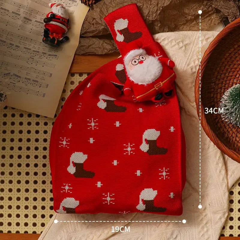 Red knitted christmas apple bag by decorbites featuring festive santa claus design with brown boots and white fur accents