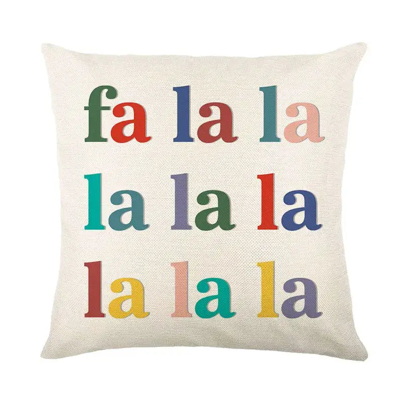Cream-colored linen throw pillow cover with multicolored fa la la christmas letter print by decorbites christmas letter