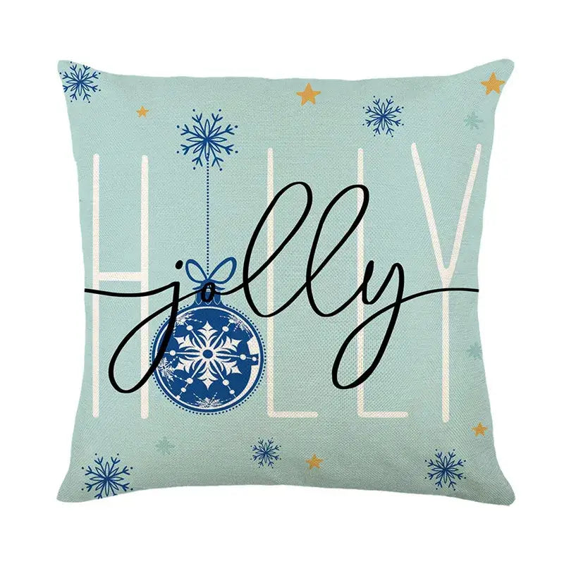 Light blue linen pillow cover with decorbites christmas letter print featuring blue ornament and jolly script design