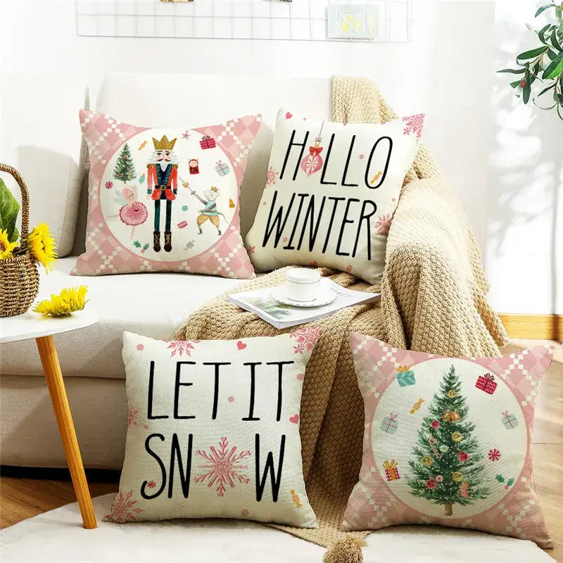 Four festive decorbites christmas letter pillow covers with nutcracker, christmas tree, and hello winter prints on linen