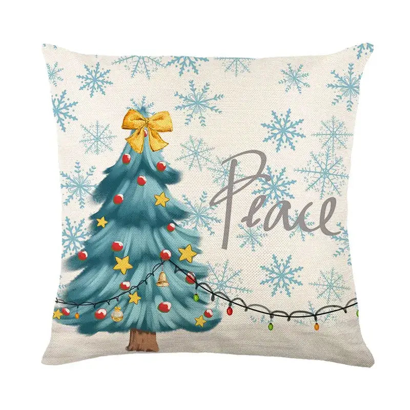 Beige linen pillow cover with decorbites christmas letter print featuring teal christmas tree and peace script design