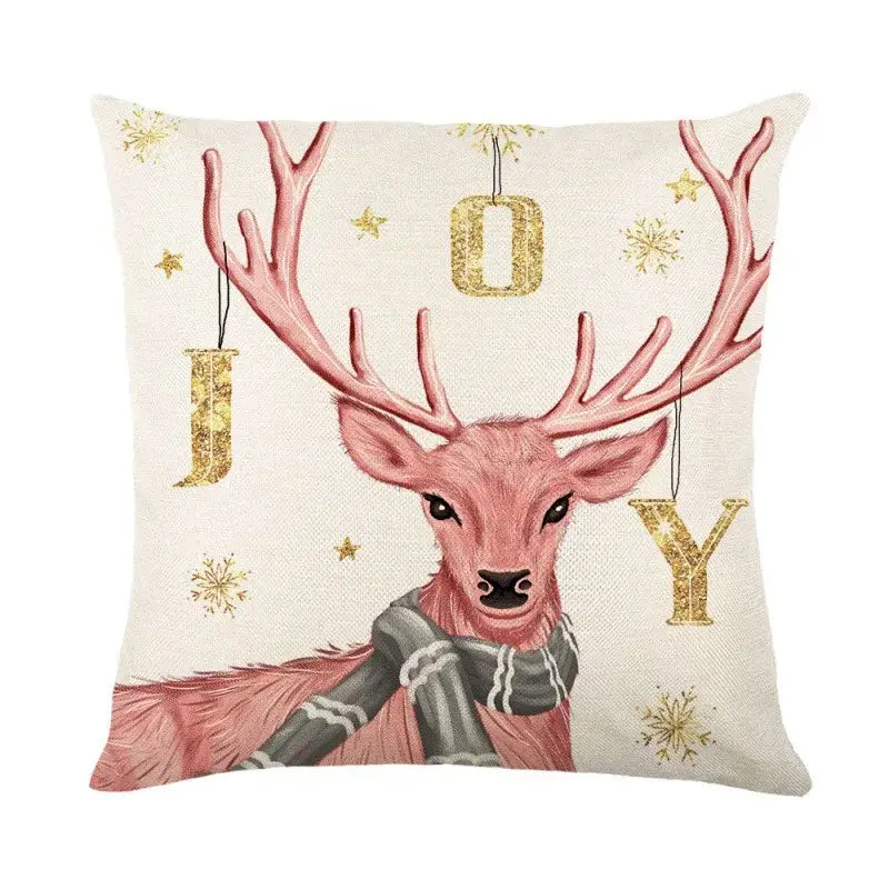 Cream-colored linen throw pillow cover with decorbites christmas letter print featuring pink deer and holiday motifs